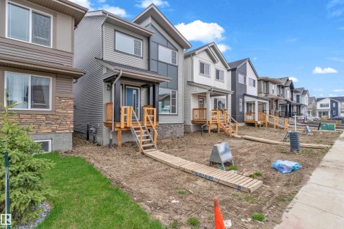 Modern two-story residence with a gray horizontal siding facade and dark trim accents - 17330 6A Street Ne, Edmonton, AB - Outdoor