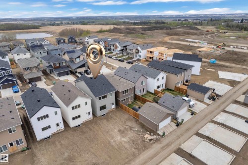 Aerial perspective showcasing a developing residential area with numerous single-family homes - 17330 6A Street Ne, Edmonton, AB - Outdoor With View