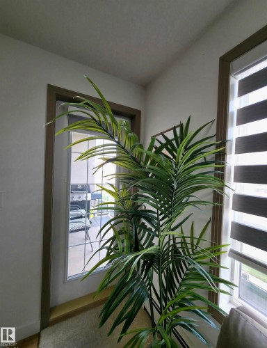 Full-lite door featuring a multi-pane grid and exterior deck - 210 5005 165 Avenue, Edmonton, AB - Indoor