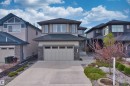 Contemporary two-story residence featuring a neutral-toned exterior with stone accents and a dark roof - 2036 Ainslie Link Link, Edmonton, AB  - Outdoor With Facade 