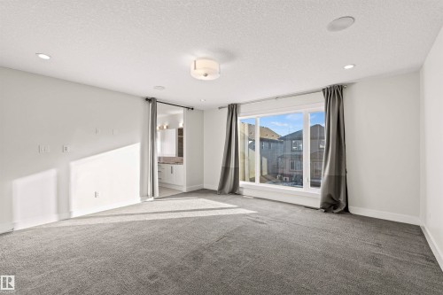 Carpeted room with recessed lighting and a flush-mount ceiling fixture - 2036 Ainslie Link Link, Edmonton, AB - Indoor Photo Showing Other Room