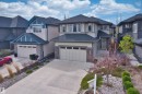 Contemporary exterior with multi-toned siding, dark gray roof, and stone accents - 2036 Ainslie Link Link, Edmonton, AB  - Outdoor With Facade 