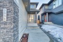 Contemporary architectural style featuring horizontal siding and stacked stone accents - 2036 Ainslie Link Link, Edmonton, AB  - Outdoor With Facade 