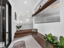 Entryway featuring decorative tile flooring, a built-in wood-finish bench, and recessed lighting - 7104 54 Avenue, Beaumont, AB  - Indoor Photo Showing Other Room 