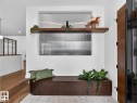 Integrated wood-finish bench seating with a coordinating floating shelf - 7104 54 Avenue, Beaumont, AB  - Indoor Photo Showing Other Room 