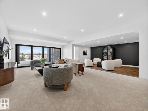 Spacious living area featuring light-toned carpeting and recessed lighting - 7104 54 Avenue, Beaumont, AB - Indoor
