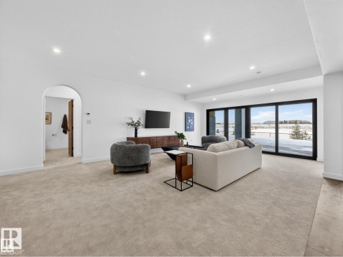Spacious living area featuring light-toned carpeting and recessed lighting - 7104 54 Avenue, Beaumont, AB - Indoor