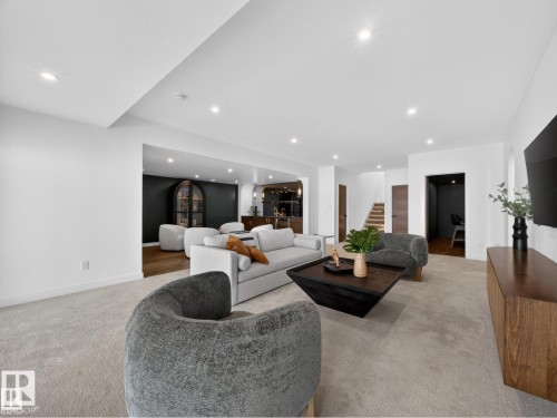 Open-concept living space with recessed lighting, light-toned carpeting, and a built-in media console - 7104 54 Avenue, Beaumont, AB - Indoor Photo Showing Living Room