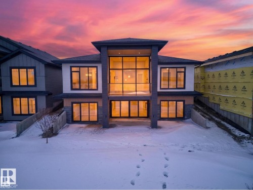 Contemporary home exterior featuring expansive windows and a multi-level design - 7104 54 Avenue, Beaumont, AB - Outdoor