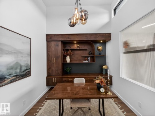 Custom built-in wood cabinetry with integrated shelving and task lighting - 7104 54 Avenue, Beaumont, AB - Indoor Photo Showing Other Room