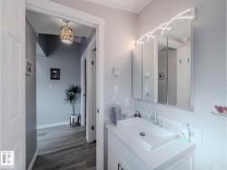 Vanity featuring a rectangular vessel sink with a chrome faucet, white countertop, and white subway tile backsplash - 