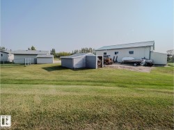 Expansive grass lawn featuring multiple outbuildings - 
