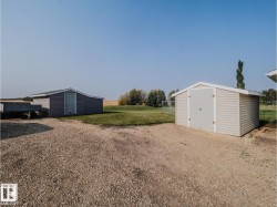 Two distinct storage sheds featuring durable siding and pitched roofs - 