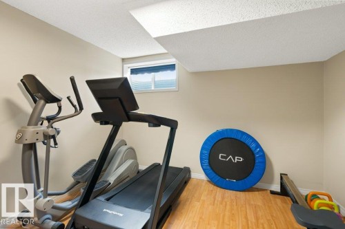 This room features light-colored walls and wood-style flooring, providing a versatile space - 7 Ash Place, St. Albert, AB - Indoor Photo Showing Gym Room