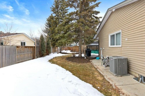 The property features an outdoor patio area with a gazebo, a wooden fence, and mature trees - 7 Ash Place, St. Albert, AB - Outdoor With Exterior