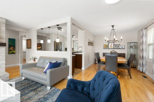 Bright and inviting living space with hardwood floors and a decorative fireplace - 7 Ash Place, St. Albert, AB - Indoor Photo Showing Living Room