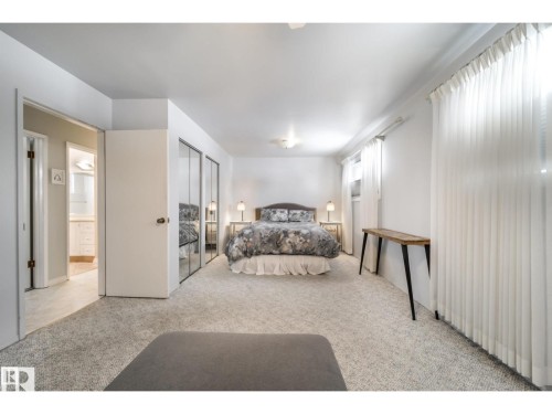 Carpeted bedroom with mirrored closet doors and recessed lighting - 10231 46 Street, Edmonton, AB 