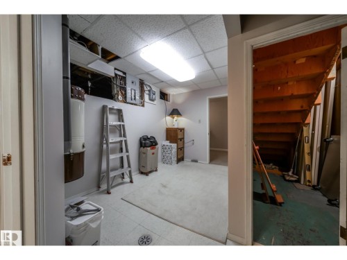 Utility room featuring tiled flooring and drop ceiling - 10231 46 Street, Edmonton, AB 