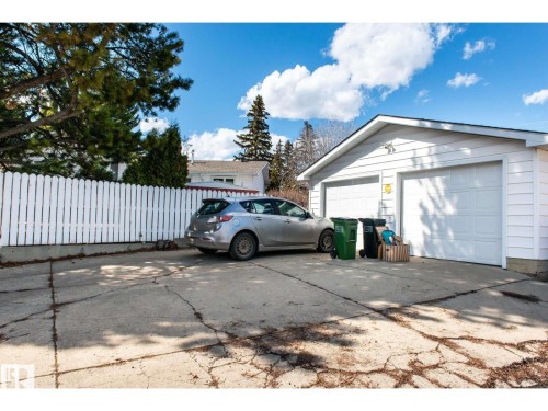 Detached two-car garage with white paneled garage doors and white siding - 10231 46 Street, Edmonton, AB 