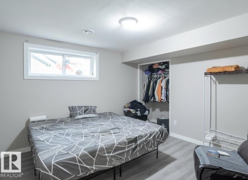 Room featuring light gray walls, wood-finish flooring, and a flush-mount ceiling light - 1728 53 Street, Edmonton, AB - Indoor Photo Showing Bedroom