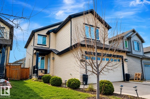 Two-story residence featuring light-colored siding, dark trim, and a two-car garage - 1728 53 Street, Edmonton, AB - Outdoor