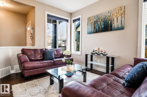 Living area featuring rich wood-finish flooring and neutral wall tones - 1728 53 Street, Edmonton, AB - Indoor Photo Showing Living Room