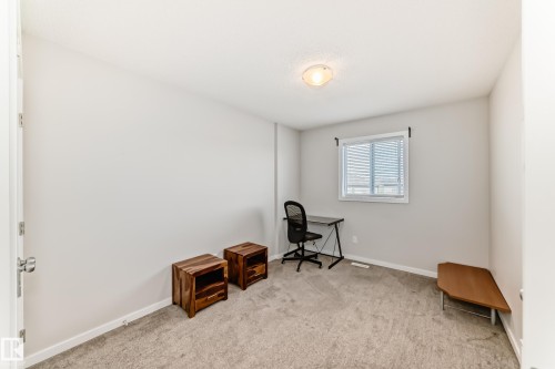 Spacious room featuring neutral carpeting, light-toned walls, and a single window with blinds - 328 Watt Boulevard, Edmonton, AB - Indoor
