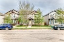 Front exterior showcasing a dual-gabled roofline, light-toned siding, and dark trim accents - 328 Watt Boulevard, Edmonton, AB  - Outdoor With Facade 