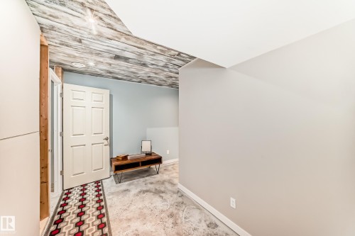 Recessed lighting illuminates a concrete-finish floor and a wood-panel ceiling - 328 Watt Boulevard, Edmonton, AB - Indoor Photo Showing Other Room