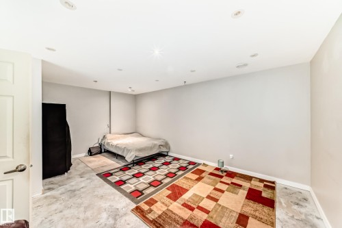 Spacious room with light gray walls, recessed lighting, and durable concrete flooring - 328 Watt Boulevard, Edmonton, AB - Indoor Photo Showing Other Room