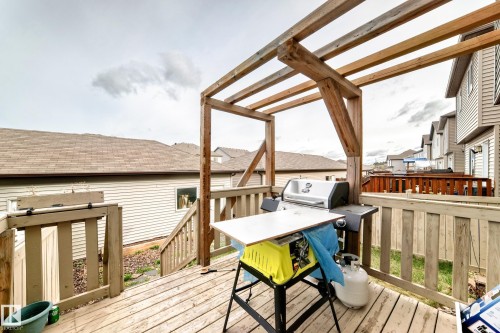 Spacious wood deck featuring a pergola, wood railing, and stairs providing access to the yard - 328 Watt Boulevard, Edmonton, AB - Outdoor With Deck Patio Veranda With Exterior