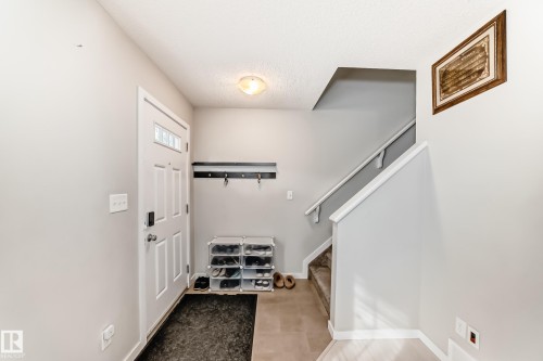 Entryway featuring a white paneled door with glass inserts, overhead flush-mount lighting, and a wall-mounted coat rack - 328 Watt Boulevard, Edmonton, AB - Indoor Photo Showing Other Room
