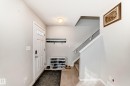 Entryway featuring a white paneled door with glass inserts, overhead flush-mount lighting, and a wall-mounted coat rack - 328 Watt Boulevard, Edmonton, AB  - Indoor Photo Showing Other Room 