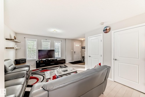 Living area featuring light wood-finish flooring, multiple windows, and recessed lighting - 328 Watt Boulevard, Edmonton, AB - Indoor Photo Showing Living Room