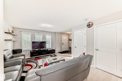 Living area featuring light wood-finish flooring, multiple windows, and recessed lighting - 
