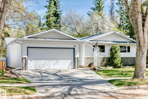 White siding residence with a stone veneer foundation, attached garage, and concrete driveway - 79 Broadview Crescent, St. Albert, AB - Outdoor