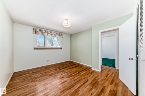 Room featuring wood-finish flooring, a double window, and a ceiling-mounted light fixture - 79 Broadview Crescent, St. Albert, AB - Indoor Photo Showing Other Room