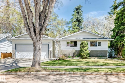 White siding exterior with a partial stone facade and a two-car garage - 79 Broadview Crescent, St. Albert, AB - Outdoor