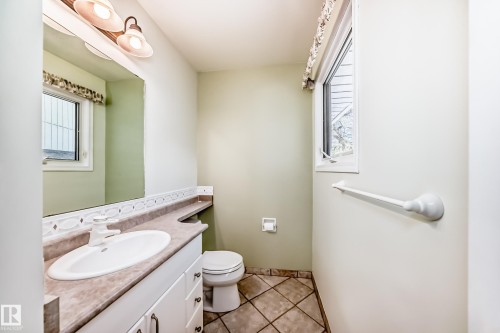 Bathroom featuring a vanity with a white oval sink, a light-toned countertop, and white cabinetry - 79 Broadview Crescent, St. Albert, AB - Indoor Photo Showing Bathroom