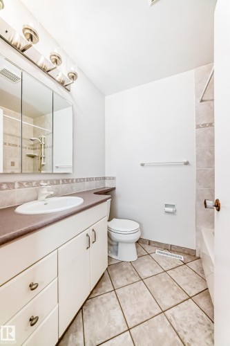 Bathroom featuring a vanity with an integrated sink, a large mirrored medicine cabinet, a tiled shower, and ceramic tile flooring - 79 Broadview Crescent, St. Albert, AB - Indoor Photo Showing Bathroom