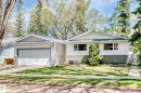 Single-story residence featuring white siding, an attached garage, a paved driveway, a manicured lawn, and mature trees - 79 Broadview Crescent, St. Albert, AB  - Outdoor 