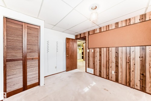 Interior room featuring wood paneling, a large corkboard, and carpet flooring - 79 Broadview Crescent, St. Albert, AB - Indoor Photo Showing Other Room
