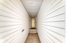 Covered entryway with light-toned siding, concrete pathway, and a recessed ceiling light - 79 Broadview Crescent, St. Albert, AB  -  Photo Showing Other Room 