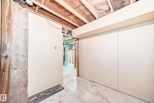 Unfinished basement space featuring exposed wood joists and subflooring, partially installed drywall, and a concrete floor - 79 Broadview Crescent, St. Albert, AB - Indoor Photo Showing Other Room