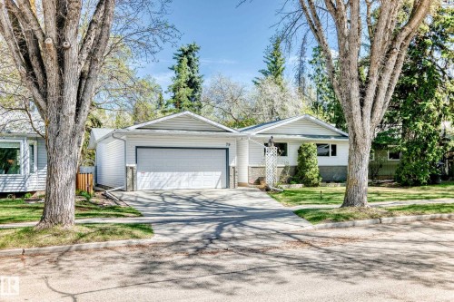 White siding exterior featuring a prominent attached garage and a concrete driveway - 79 Broadview Crescent, St. Albert, AB - Outdoor