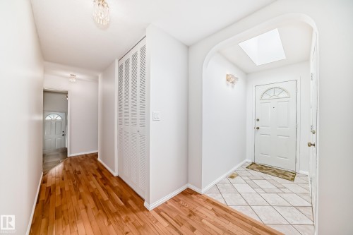 Entryway featuring an arched ceiling detail, skylight, and white paneled door with an arched window - 79 Broadview Crescent, St. Albert, AB - Indoor Photo Showing Other Room