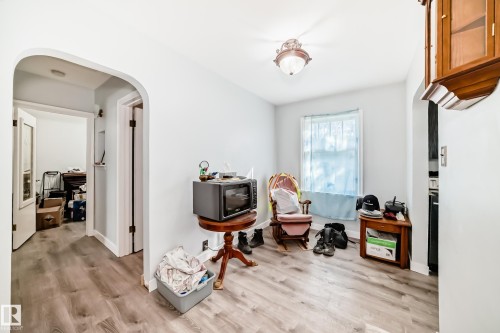 Spacious room featuring wood-finish flooring and light-toned walls - 11303 60 Street, Edmonton, AB - Indoor Photo Showing Other Room
