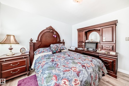 Bright room with light wood-finish flooring - 11303 60 Street, Edmonton, AB - Indoor Photo Showing Bedroom