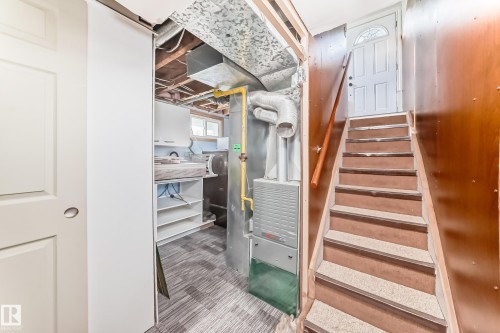 Lower level utility area featuring a furnace, exposed ductwork, and built-in shelving - 11303 60 Street, Edmonton, AB - Indoor Photo Showing Other Room
