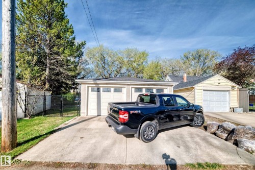 Two-car detached garage with panel doors and a concrete driveway - 11303 60 Street, Edmonton, AB - Outdoor